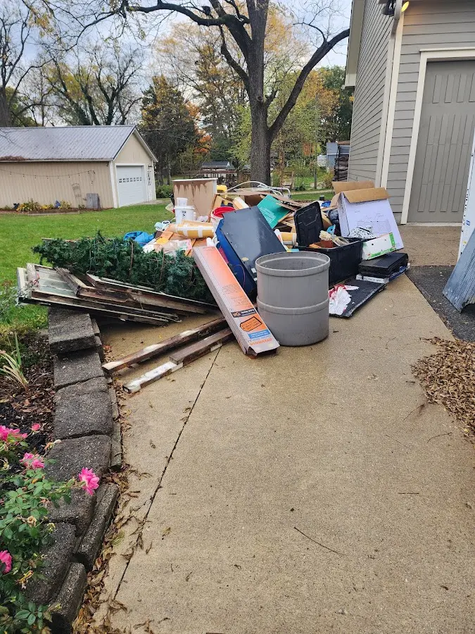 Dumpster being loaded with debris for 12 Yard Dumpster Rental in Pontoon Beach